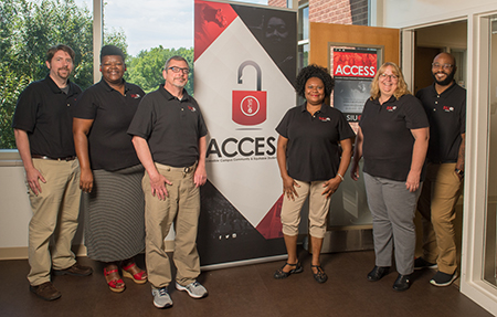 ACCESS staff members standing left to right are Andy Koch, Calandra Mitchell, Jim Boyle, Berthine Blanc, Michelle Nickerson and Dominic Dorsey.